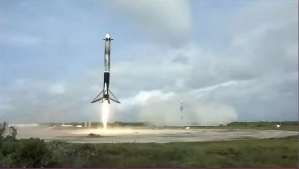 A rocket taking off from a launch pad

Description automatically generated