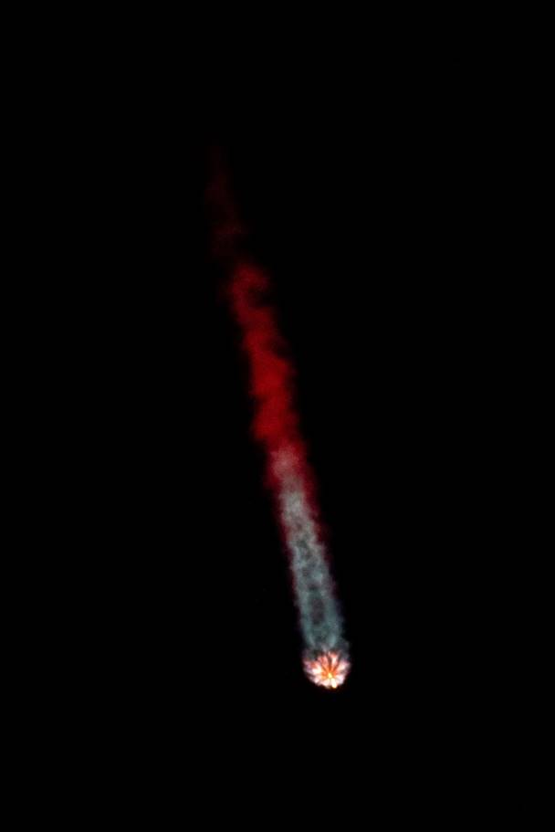 A red and white fireball in the sky

Description automatically generated